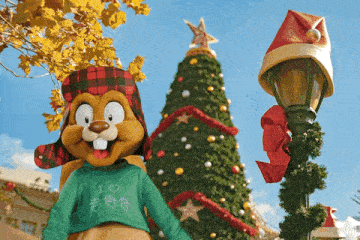 a beaver mascot wearing a sweater that says i love christmas