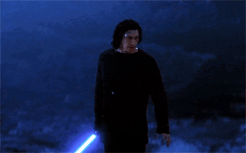 a man in a black shirt is holding a blue light saber in his hand