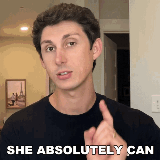 a man says " she absolutely can " with his finger