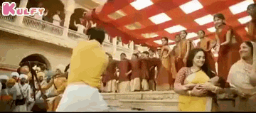 a group of people are dancing in a room with a red ceiling .