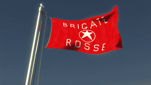 a red flag that says brigate rosse is flying in the wind