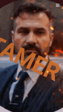 a close up of a man 's face with the word tamer written on it