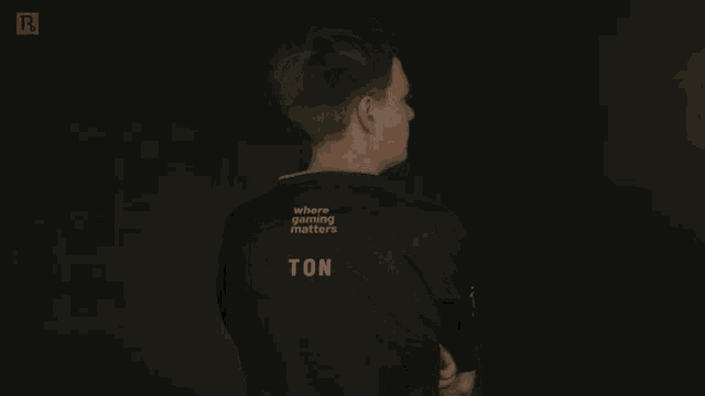a man stands with his arms crossed and his shirt says ate on the sleeve
