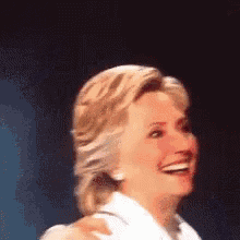 a woman in a white shirt is smiling with her arm around her shoulder