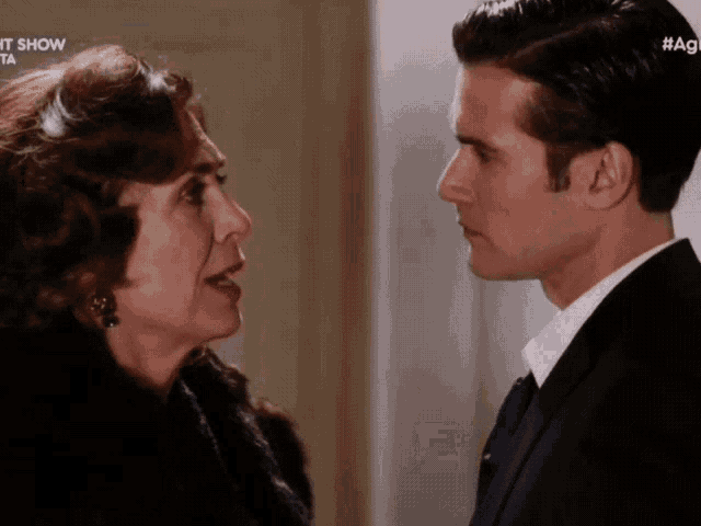 a man and a woman are looking at each other with the word show on the bottom right