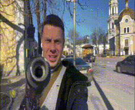 a man is holding a gun in front of a church in a city