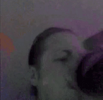 a close up of a man 's face with his eyes closed and a purple background