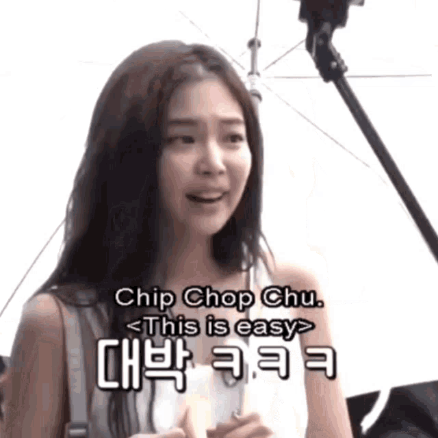 a woman with long hair is holding an umbrella and says chip chop chu this is easy