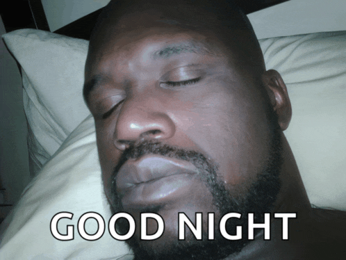 a man with a beard is sleeping in a bed with the words good night on the bottom