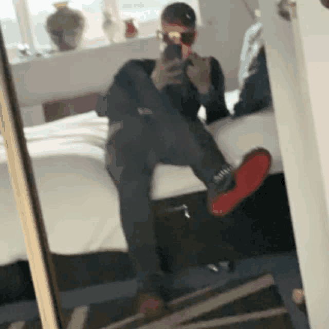 a person is taking a picture of themselves in a mirror