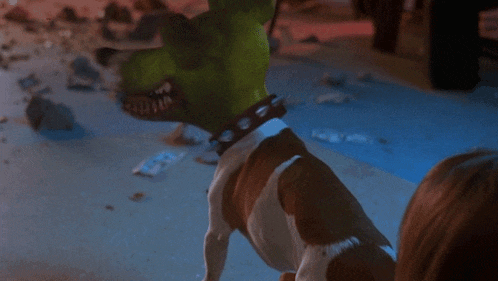 a brown and white dog with a green mask on its head