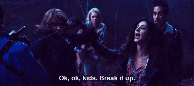 a group of people in a dark room with the words ok ok kids break it up written on the bottom
