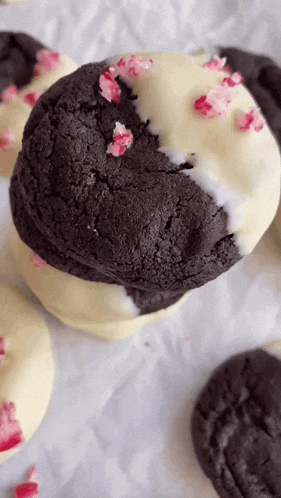 a close up of a black and white cookie with candy canes on it .