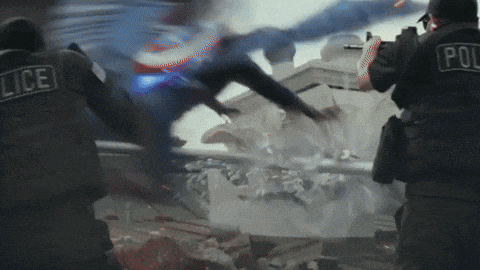 two police officers are fighting a man in a blue suit