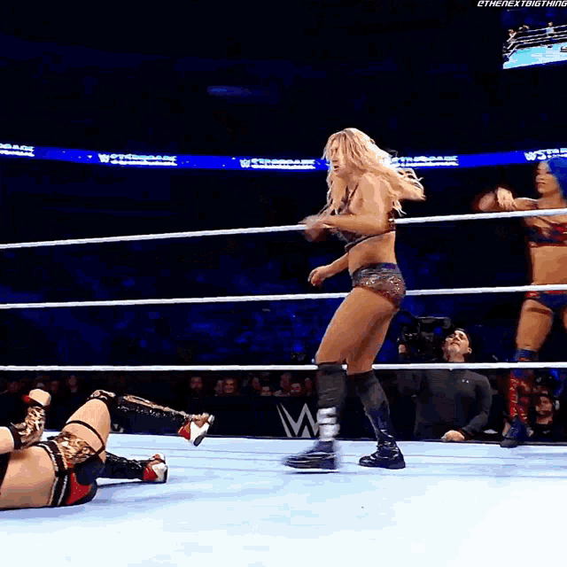 a woman in a wrestling ring with the word w on the bottom of the screen