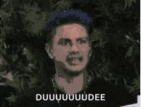 a man with blue hair is making a funny face and the words duuuuuuuudee are on the bottom