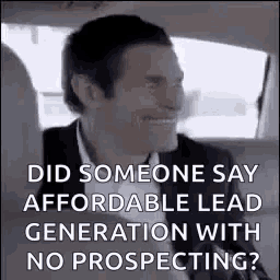 a man in a suit and tie is smiling in a car .