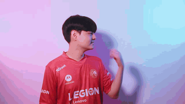 a man wearing a red jersey that says legion on the front