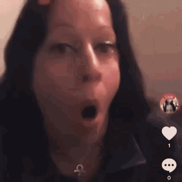 a close up of a woman 's face with a live button