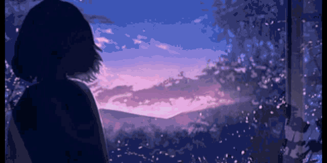 a silhouette of a girl looking out a window at a sunset .