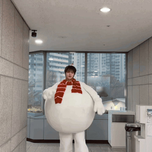 a man dressed as a snowman with a scarf around his neck