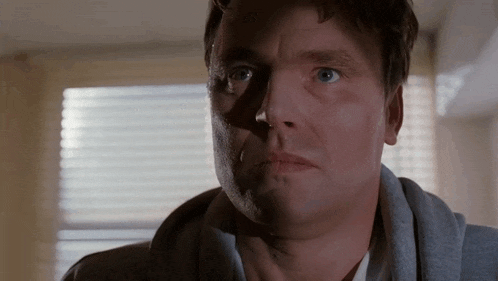 a close up of a man 's face with a serious look on his face .