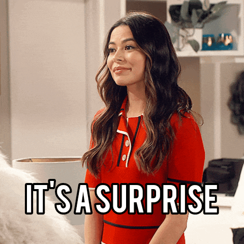 a woman in a red dress with the words it 's a surprise behind her