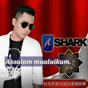 a man wearing sunglasses and a white jacket stands in front of a red curtain that says shark
