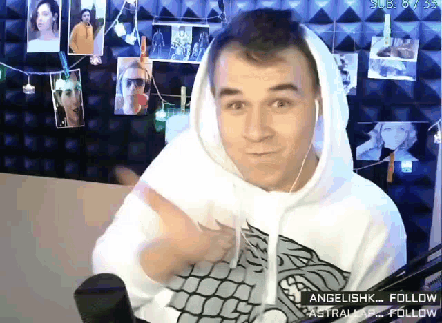 a man wearing a white hoodie with a game of thrones logo