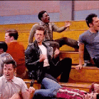 a group of people are sitting on the bleachers in a stadium .