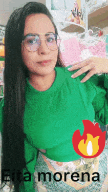 a woman wearing glasses and a green top with the name eita morena on the bottom right