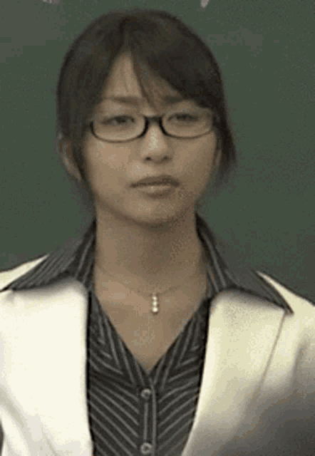 a woman wearing glasses and a striped shirt