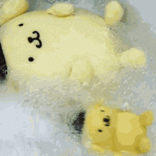 a stuffed animal is floating in a bathtub with bubbles coming out of it 's mouth .