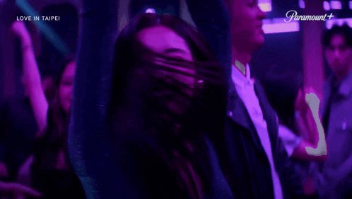 a woman is dancing in front of a sign that says paramount+