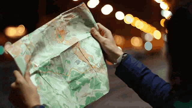 a person is holding a map in their hands that says ' a ' on the bottom