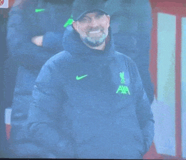 a man wearing a nike jacket with the word axa on it