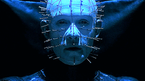 a close up of a person 's face with nails in it 's head