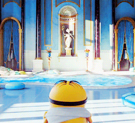 a minion wearing sunglasses and a scarf stands in front of a swimming pool