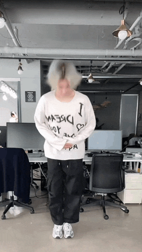 a person wearing a white sweater that says i love you on it