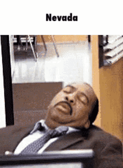 a man in a suit and tie is sleeping with his eyes closed in nevada