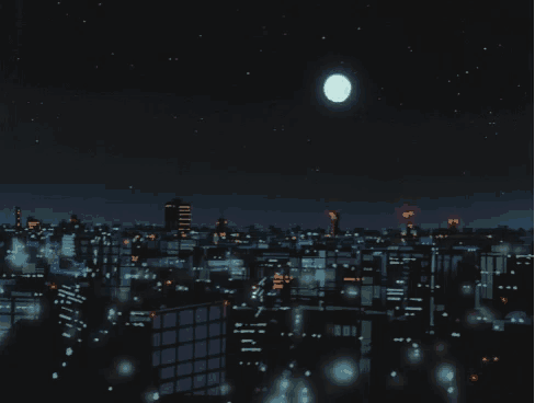 a full moon is visible over a city at night