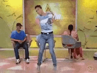a man is dancing on a stage in front of a sbt logo