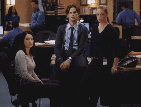 a man and two women are standing in a room with a name tag that says ' toyberry ' on it