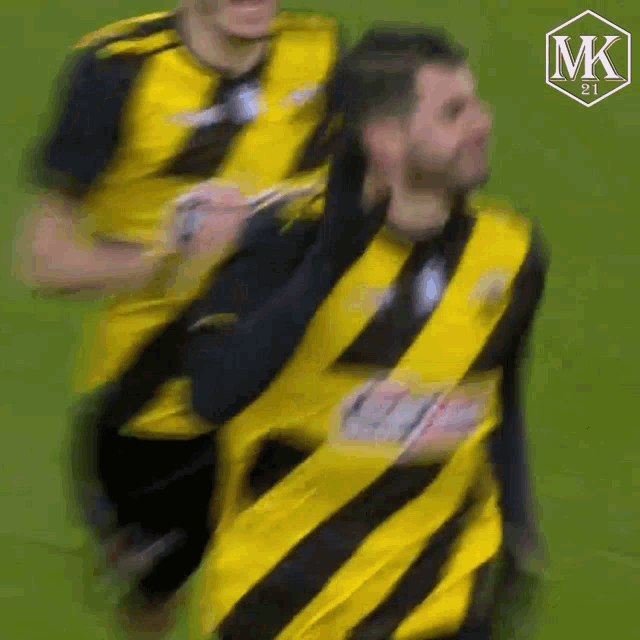 a blurry picture of a man in a yellow and black striped shirt
