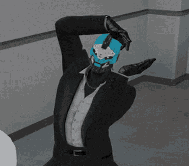 a man in a suit has a blue mask on his head and gloves on