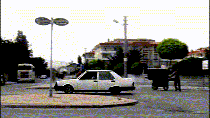a white car is driving down a street in front of a sign that says ' istanbul '
