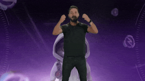 a man in a black shirt stands in front of a purple background