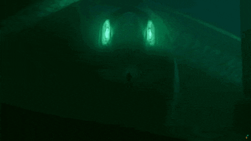 a monster with glowing green eyes is swimming in the dark .
