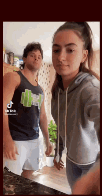 a man and a woman are standing next to each other and the man is wearing a shirt that says life is good