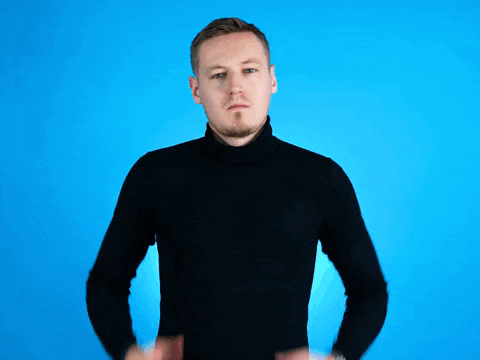 a man in a black turtleneck sweater is holding his chest with his hands